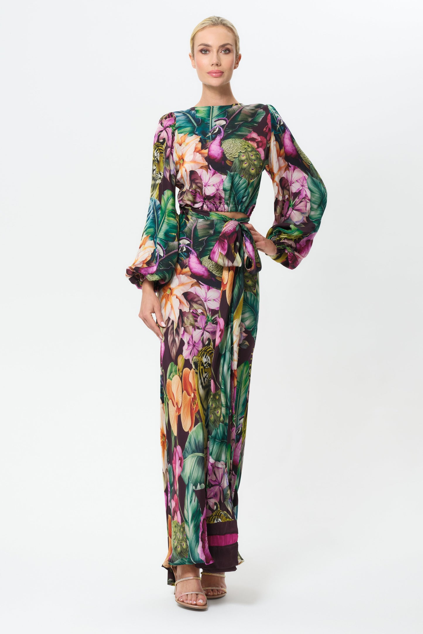 Woman wearing a colorful floral outfit on a white background