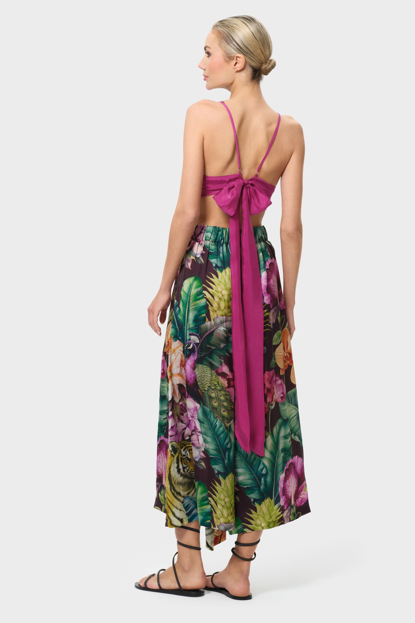 Woman wearing a colorful floral palazzo pants on a white background