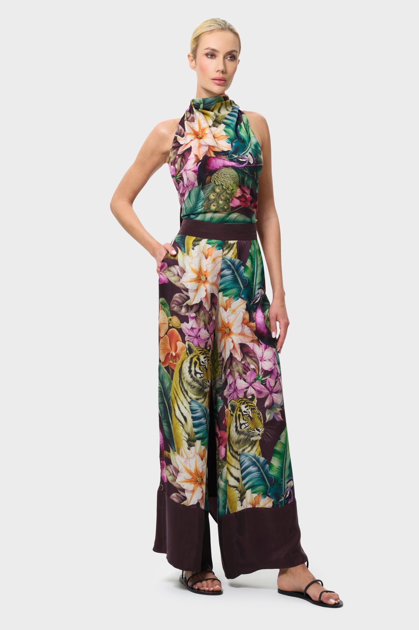 Woman wearing a colorful floral outfit on a white background