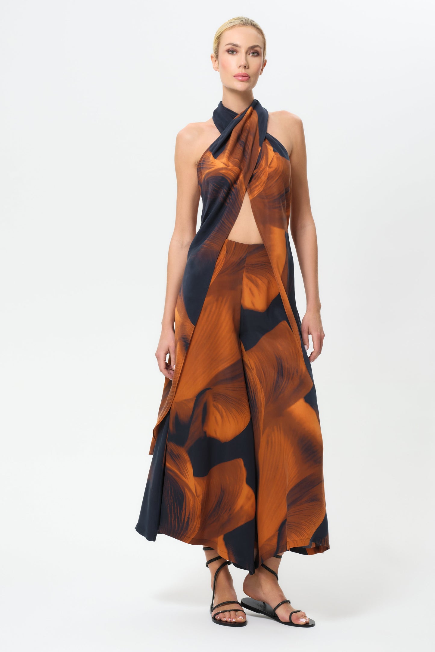 Woman wearing an patterned top and patterned skirt on a white background