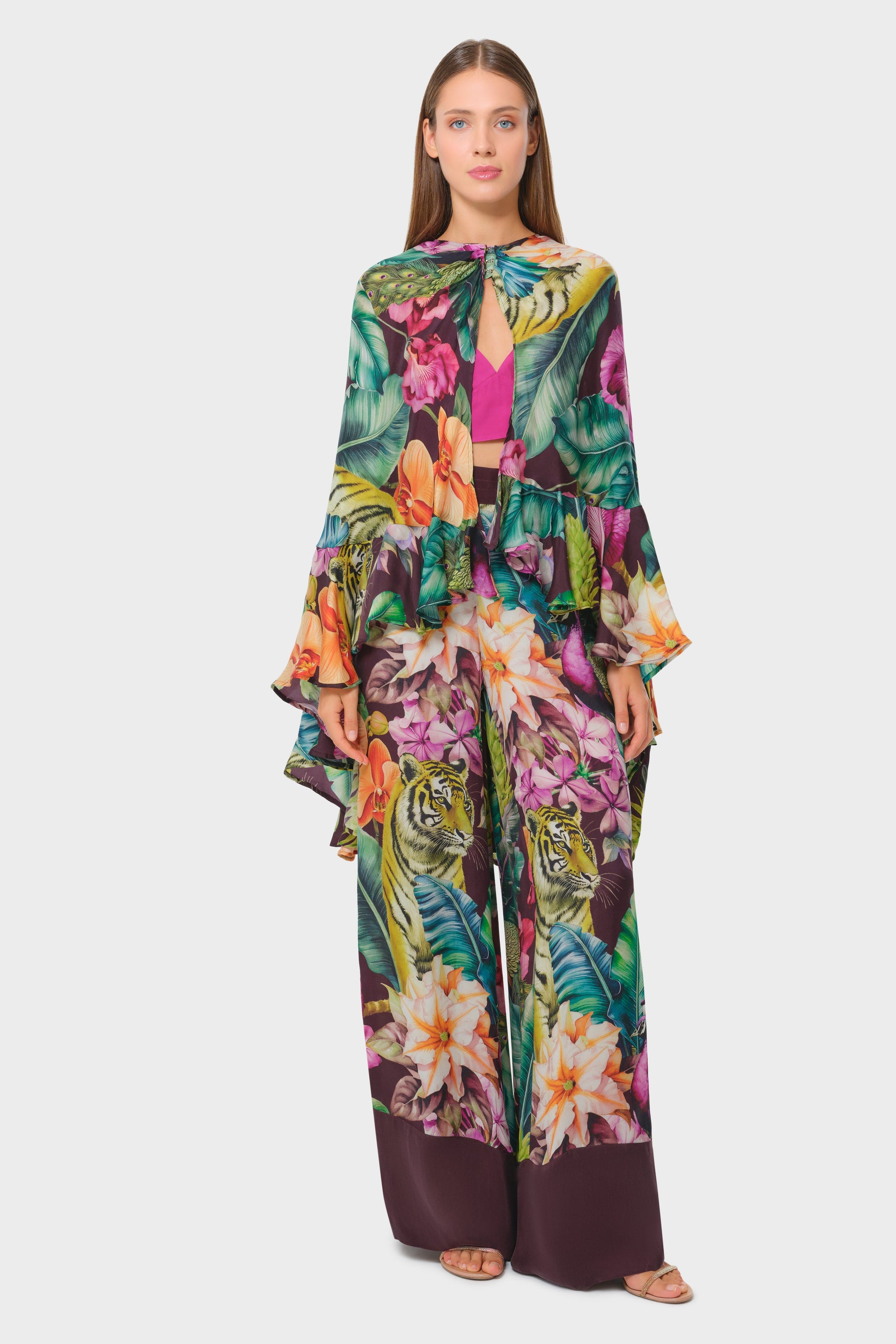 Woman wearing a colorful floral outfit on a white background