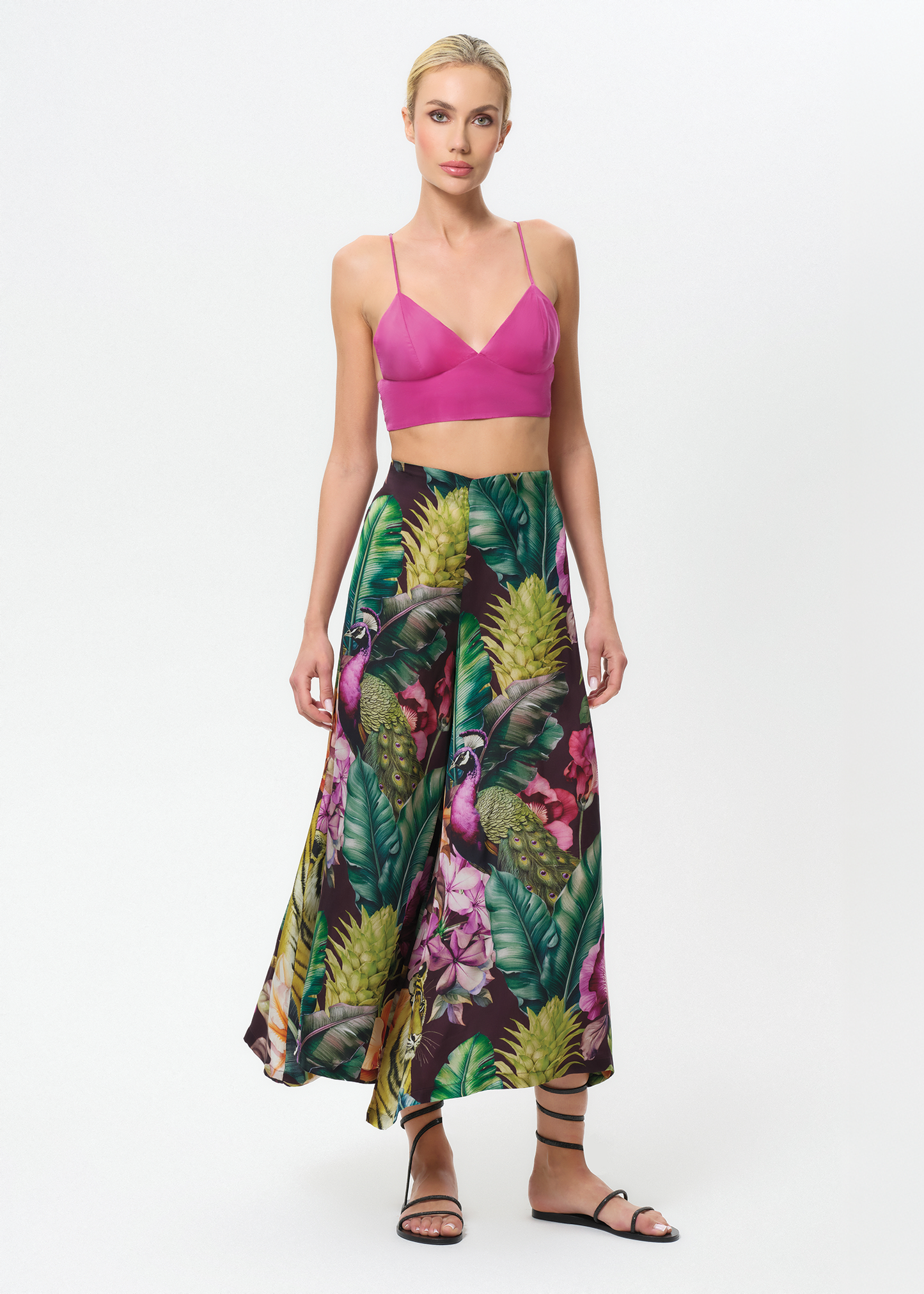 Woman wearing a colorful floral palazzo pants on a white background