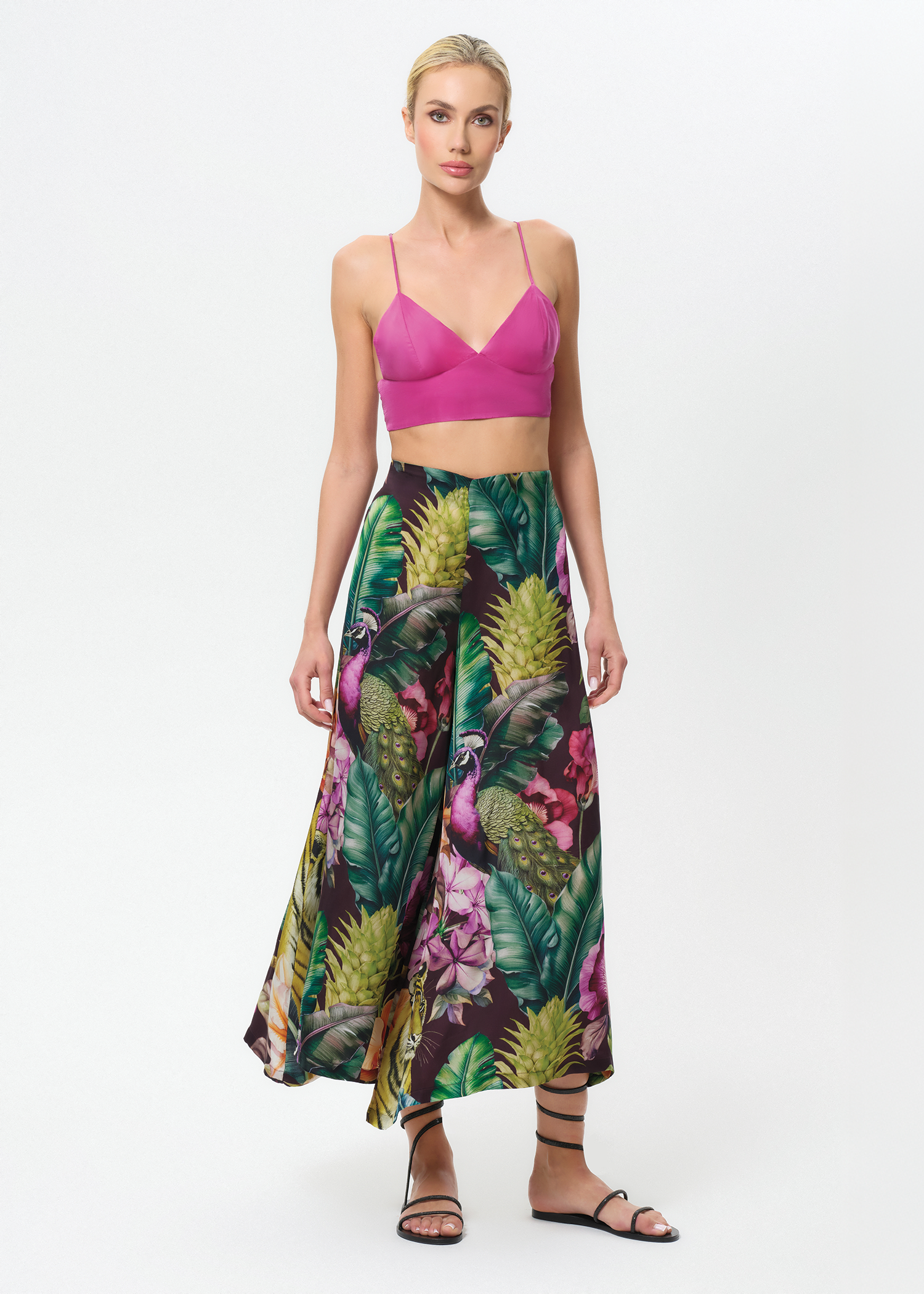 Woman wearing a colorful floral palazzo pants on a white background