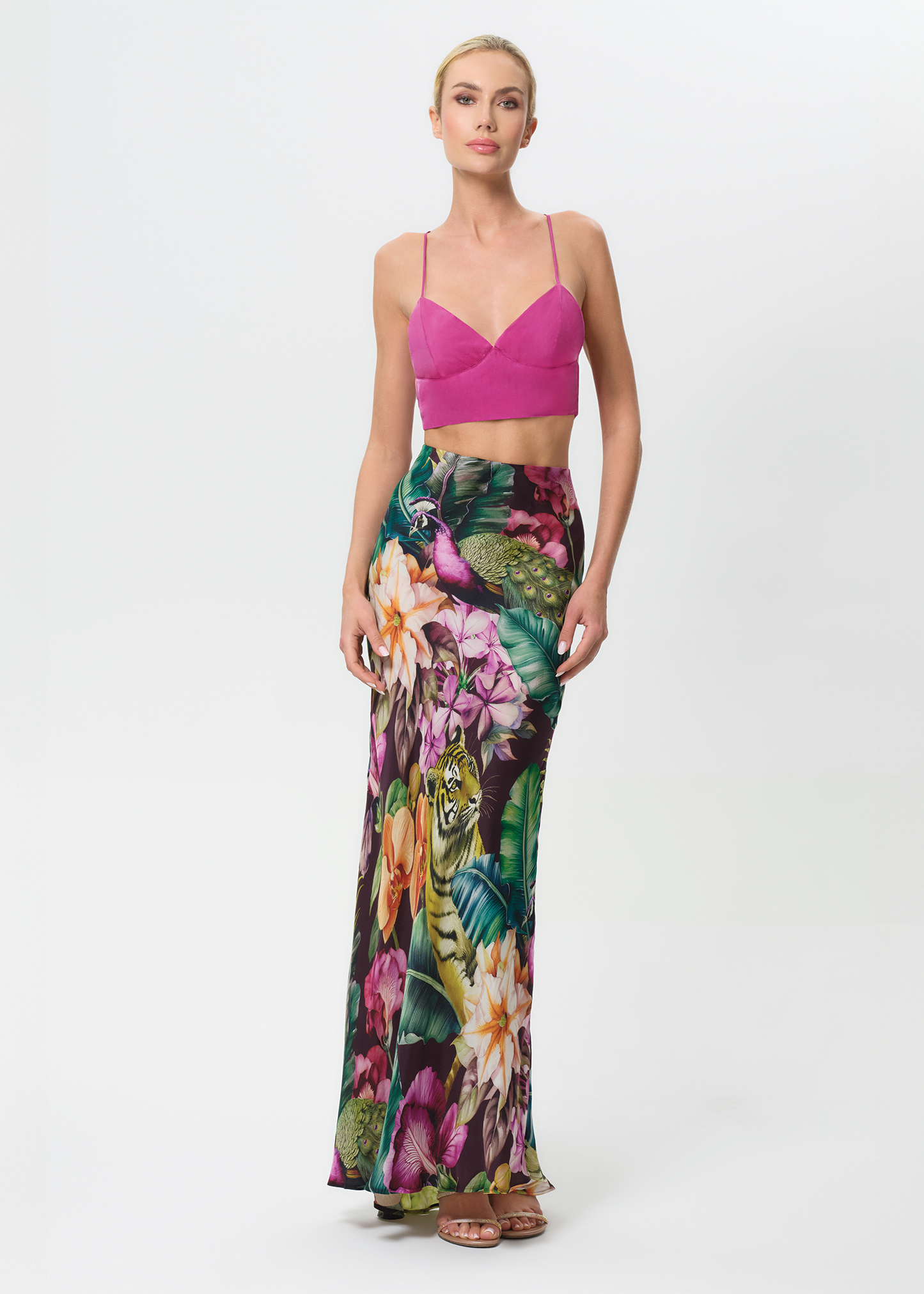 Woman wearing a colorful floral outfit on a white background