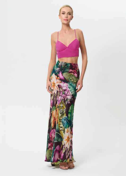 Woman wearing a colorful floral outfit on a white background