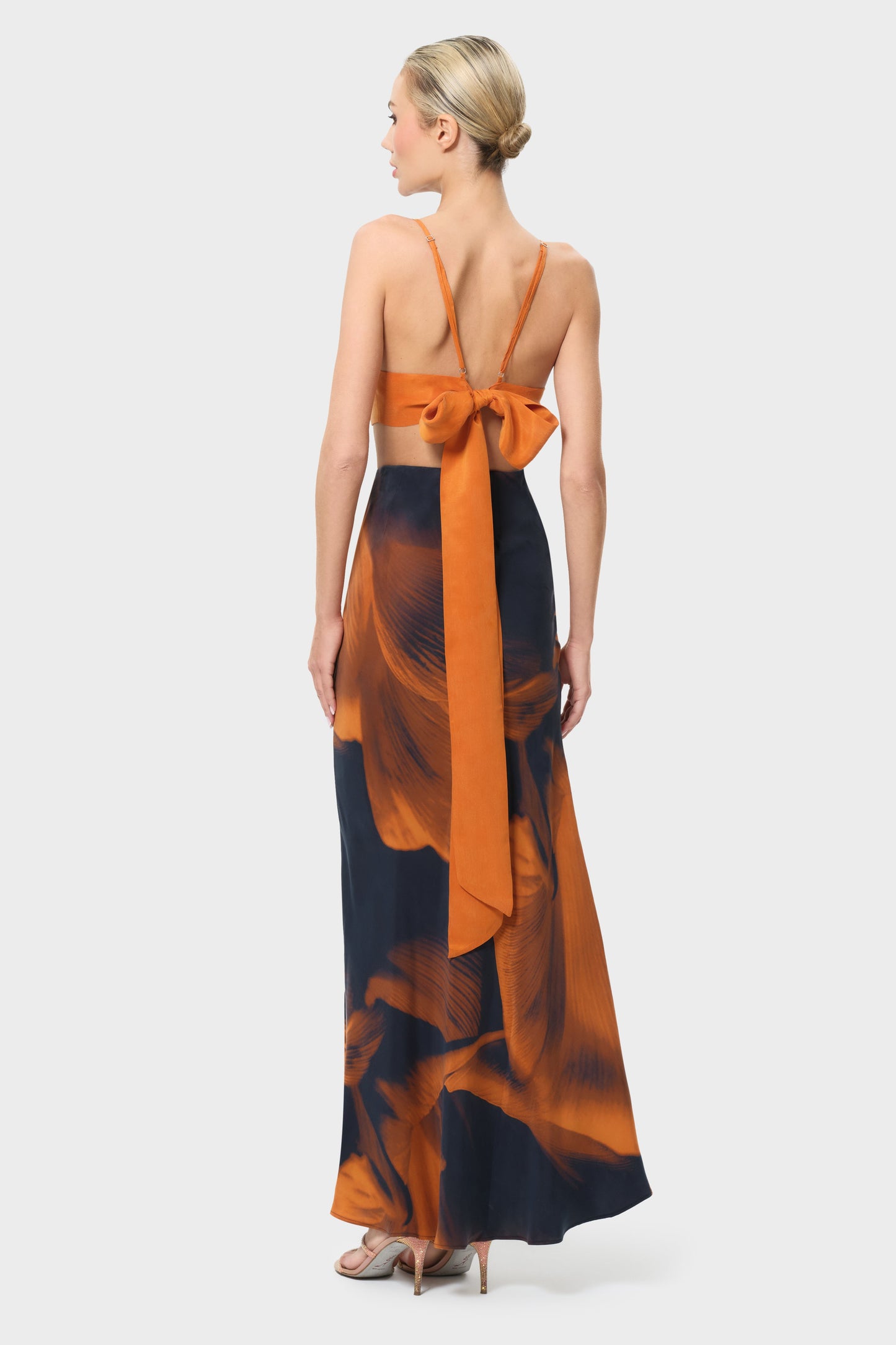 Woman wearing an orange and black skirt on a white background