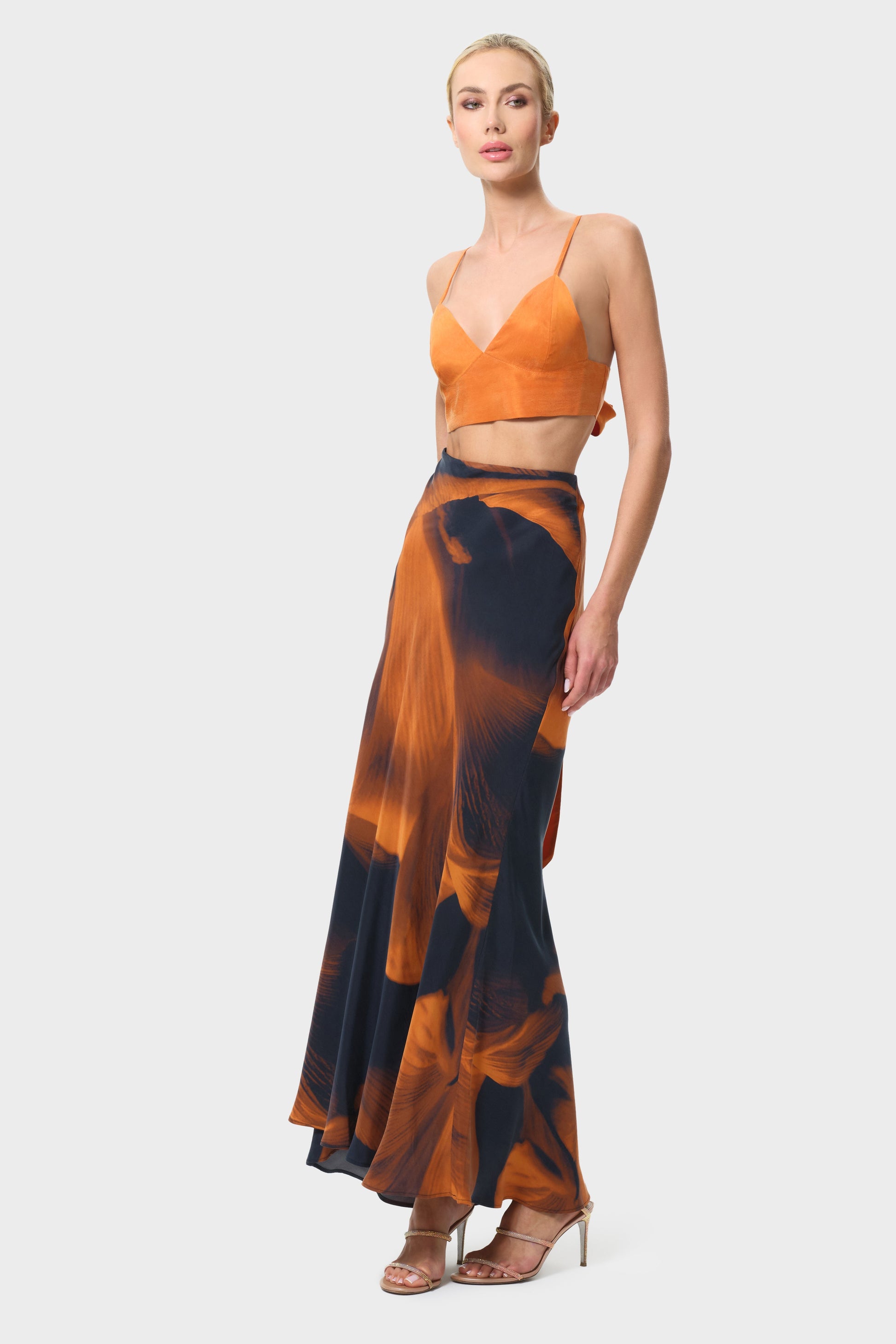 Woman wearing an orange and black skirt on a white background