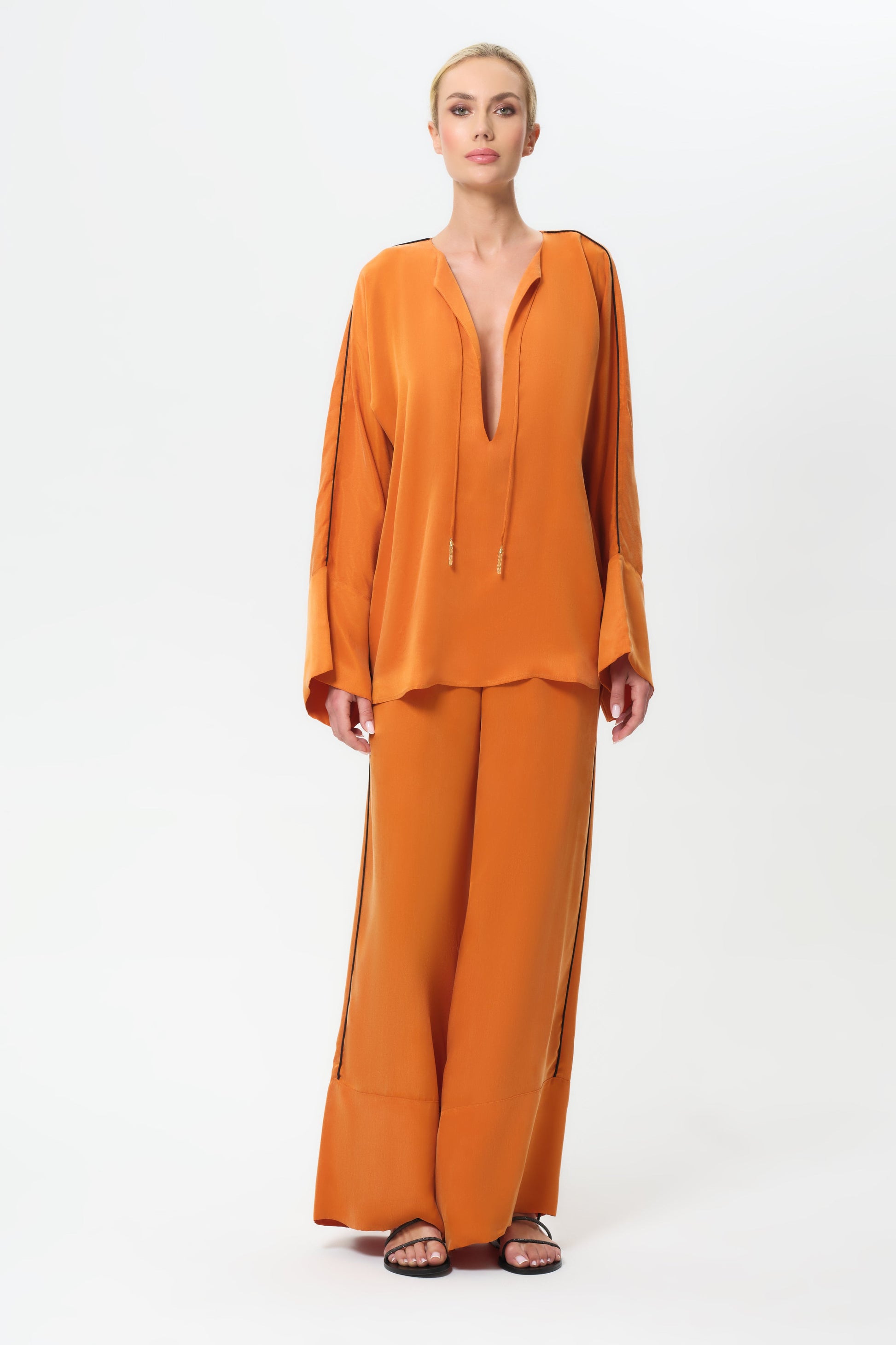 Woman wearing an orange outfit on a white background